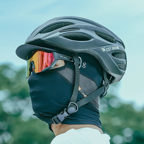 A cyclist wearing a black Cool Ride UV Sun Mask and helmet for full-face UV protection during outdoor rides.